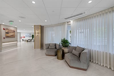 Bright common area with comfortable seating and large windows