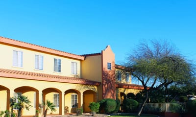 Building exterior of Pennington Gardens with landscaping