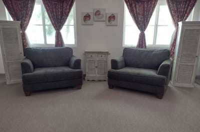 Cozy seating area with two sofas and decorative curtains