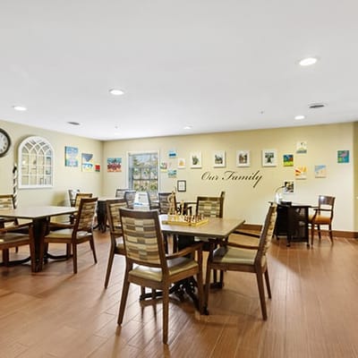 A spacious dining area with tables and art on the walls