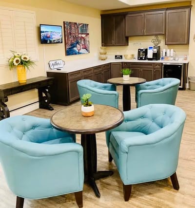 Bright common area with seating and coffee station