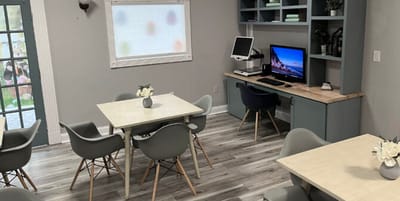 Bright and modern common area with tables and chairs
