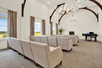Bright common area with seating and a piano
