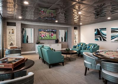 Bright interior common area with seating and a TV.