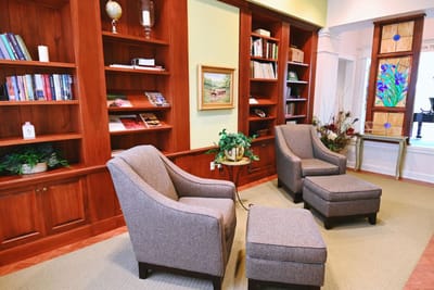 Cozy seating area in a common space with bookshelves