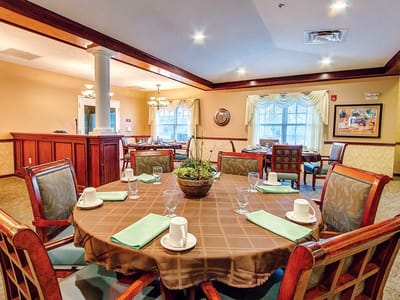 Dining area set for a meal with coffee and table settings