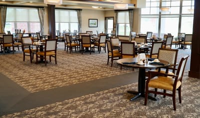 Dining area with tables and chairs set for meals