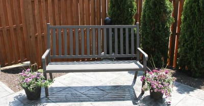 Outdoor bench surrounded by flowers in a landscaped area
