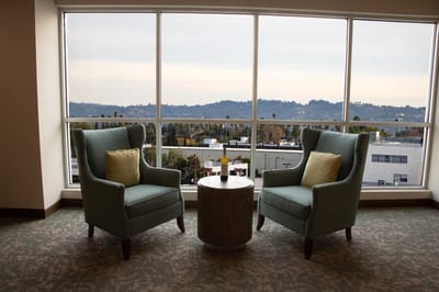 Two armchairs by a window with a view