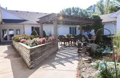 Outdoor seating area with flowers and a trellis
