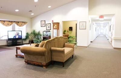 Interior view of a common area with a couch and TV