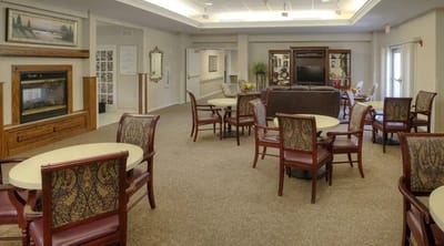 Common area with tables and chairs in a bright room