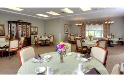 Bright dining area with floral centerpieces and arranged tables