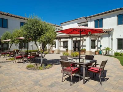 Outdoor seating area with tables and umbrellas