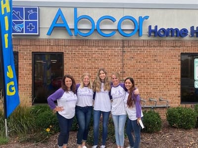 Staff members posing outside the facility
