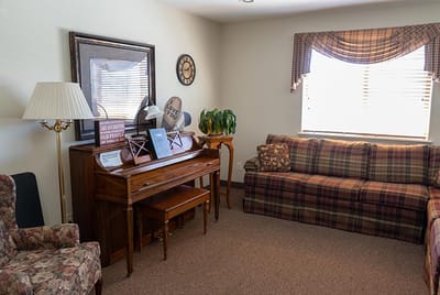 Cozy common area with a piano and seating
