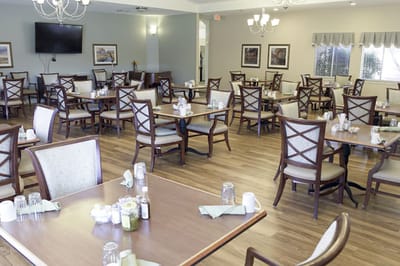 Dining area with tables and chairs in a bright room