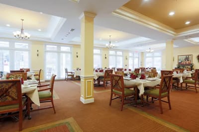 Bright dining room with tables set for meals