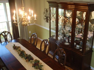 Elegant dining room setup with chandelier and display cabinet