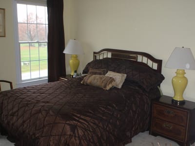 Cozy bedroom with a large window and decorative lamps