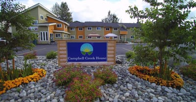 Entrance sign for Campbell Creek House with landscaped garden