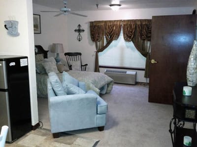 Cozy resident room with bedding and seating area