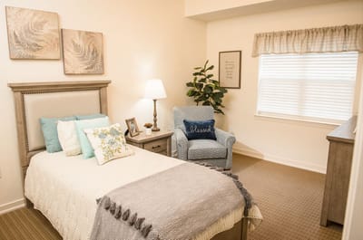 Cozy private room with a bed and chair