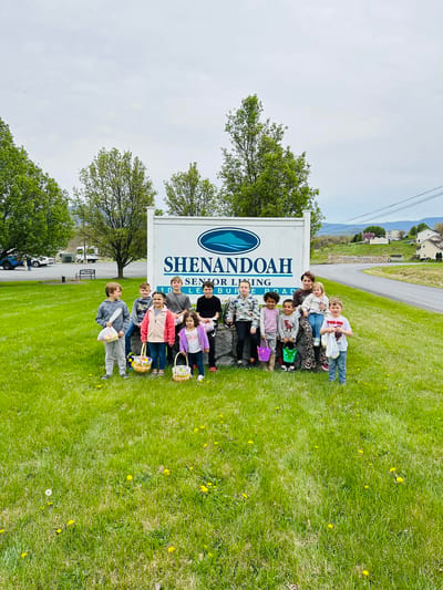 Children gathered outside the Shenandoah Senior Living sign