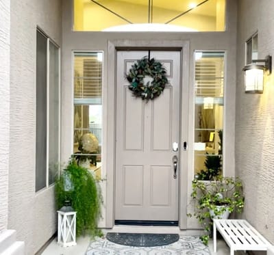 Front entrance of a senior living facility with greenery