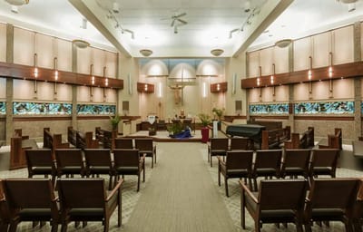 Interior view of a chapel with wooden chairs and altar