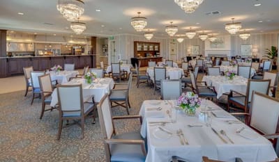 Elegant dining room setup with tables and flowers