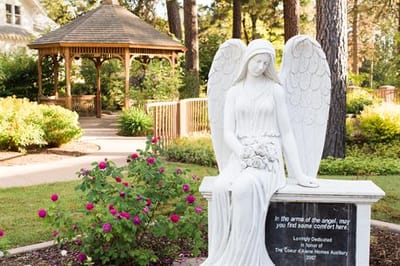 A serene angel statue in a garden setting