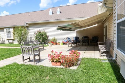 Outdoor seating area with flower beds and patio furniture