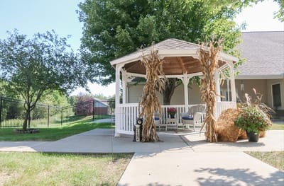 Outdoor gazebo decorated with autumn corn stalks