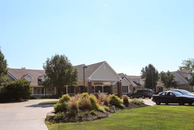 Exterior view of the assisted living facility with landscaped gardens