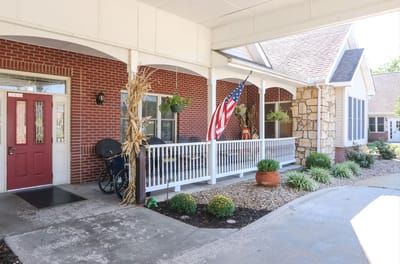 Entrance of a senior living facility with American flag