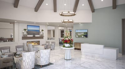 Bright and modern lobby area with seating and floral arrangement