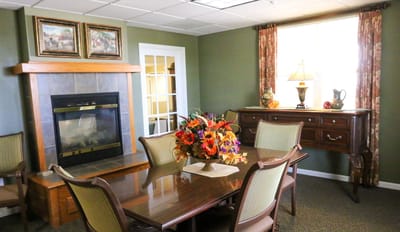 Cozy common area with fireplace and floral arrangement