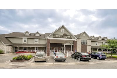Exterior view of Vintage Park facility entrance with parked cars