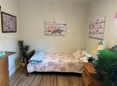 Cozy private room with floral decor and bed
