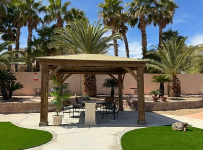 Shaded outdoor gazebo surrounded by palm trees