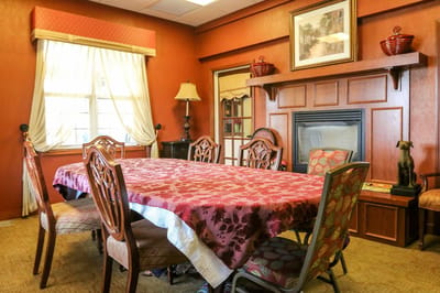 Cozy common area with a large dining table and fireplace