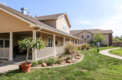 Exterior view of a senior living facility with landscaped garden