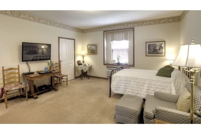 Private resident room with a bed and seating area