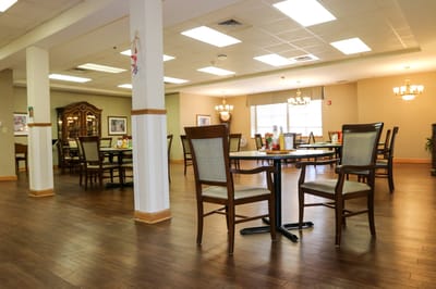 Dining area with tables and chairs in a well-lit room