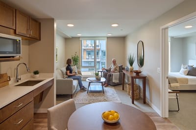 Residents conversing in a cozy living room setting