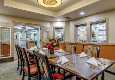 A beautifully set dining room with floral centerpiece