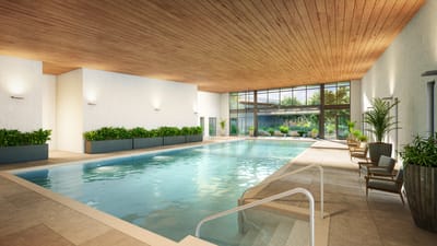 Indoor swimming pool area with plants and natural light