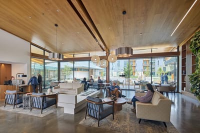 Shared lounge area with residents and staff interacting