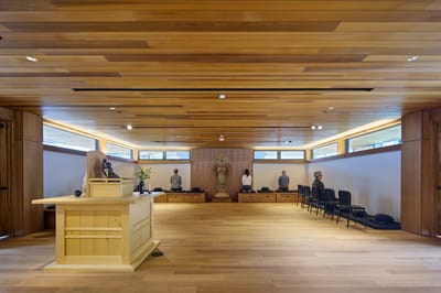 A serene common area with meditation seating and wooden decor